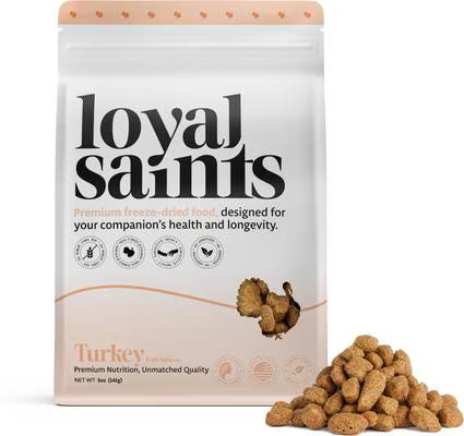 Loyal Saints premium freeze-dried turkey pet food packaging with some food on a white background